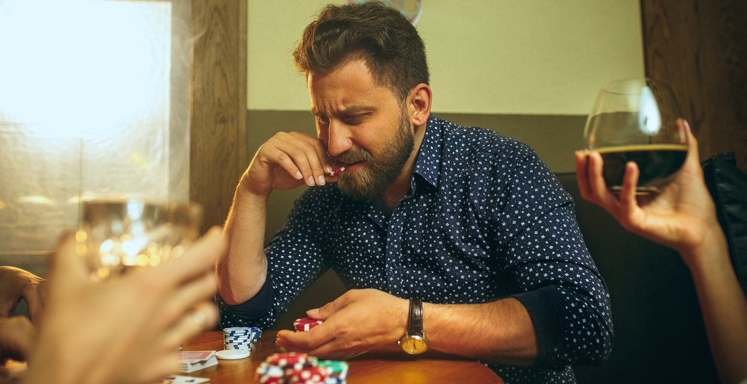 Man thinking about his next move during a card game with friends